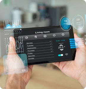 Person using a tablet to control smart home living room environment.