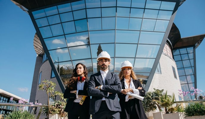 Business professionals in front of modern office building for Build Services.
