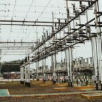 Electrical infrastructure at a utility hub with transformers and wiring.