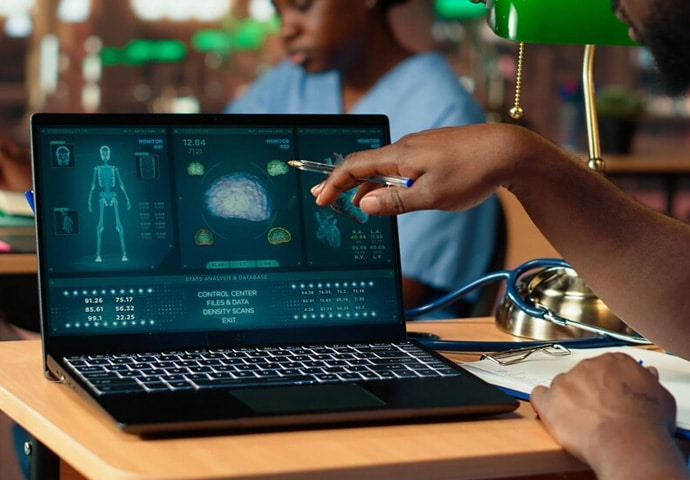 Person analyzing medical data on a laptop for healthcare automation.