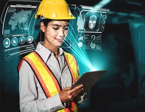 Female engineer with safety helmet and vest using digital tablet in high-tech environment.
